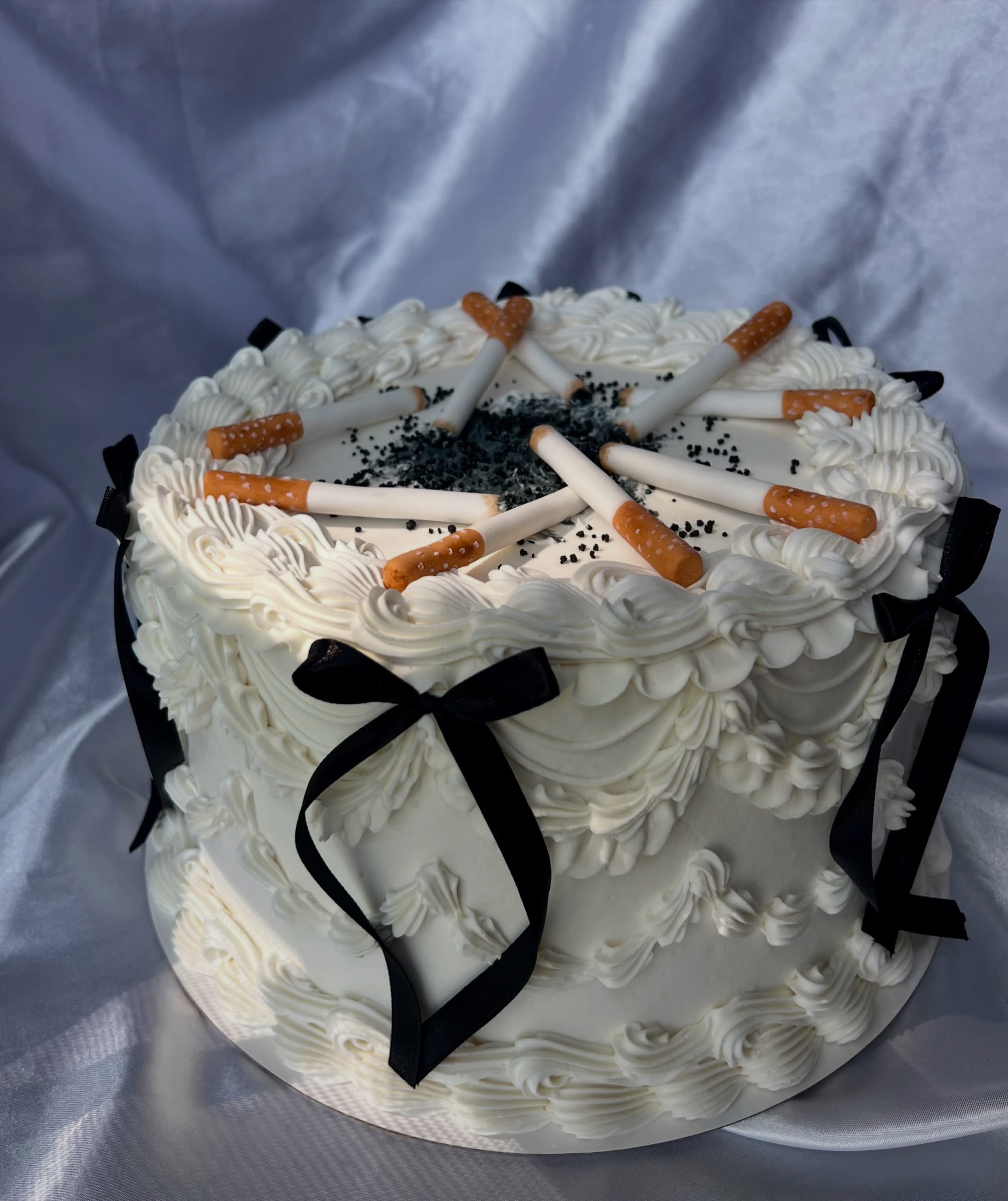 Novelty vintage cake with cigarette decorations